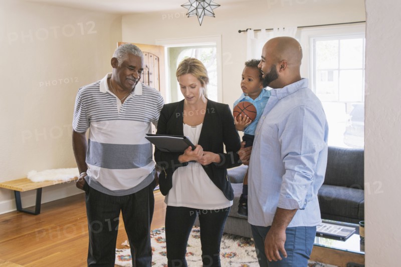 Real estate agent and clients using digital tablet