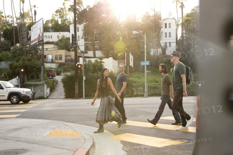 Friends walking in city crosswalk