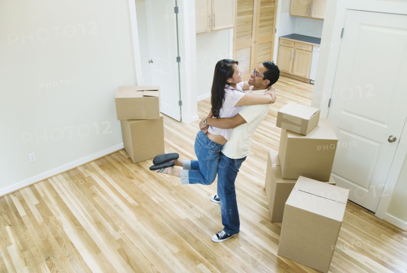 Asian couple hugging in new house