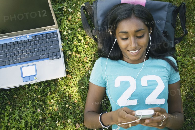Indian female college student listening to mp3 player