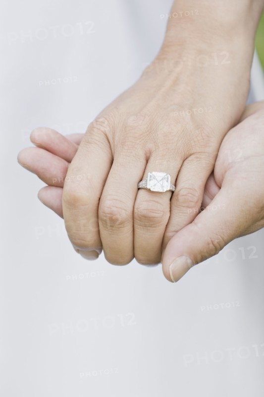 Close up of Asian woman's wedding ring