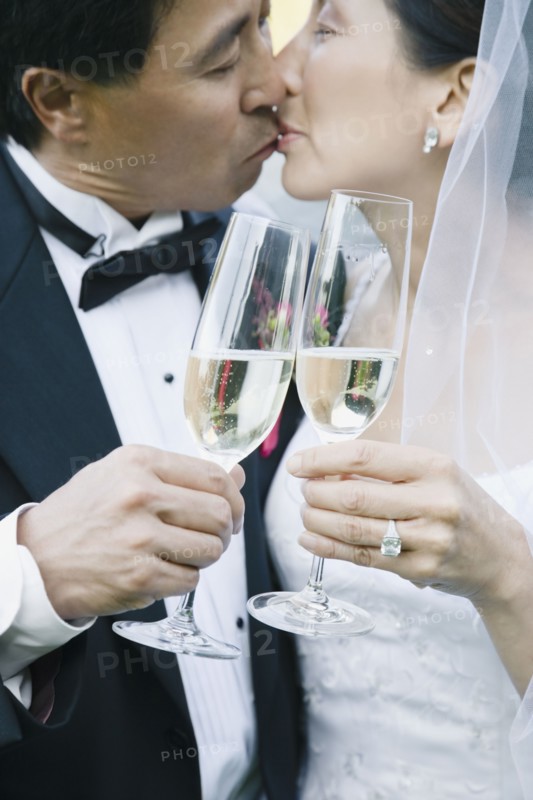 Asian newlyweds kissing
