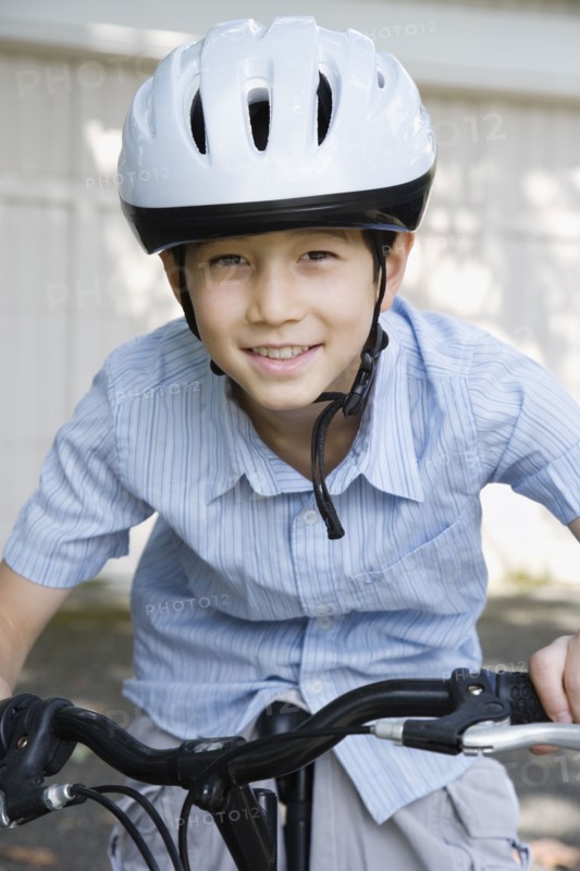 Asian boy riding bicycle