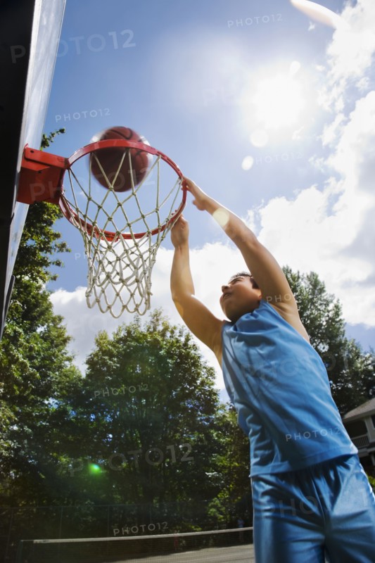 Asian boy playing basketball