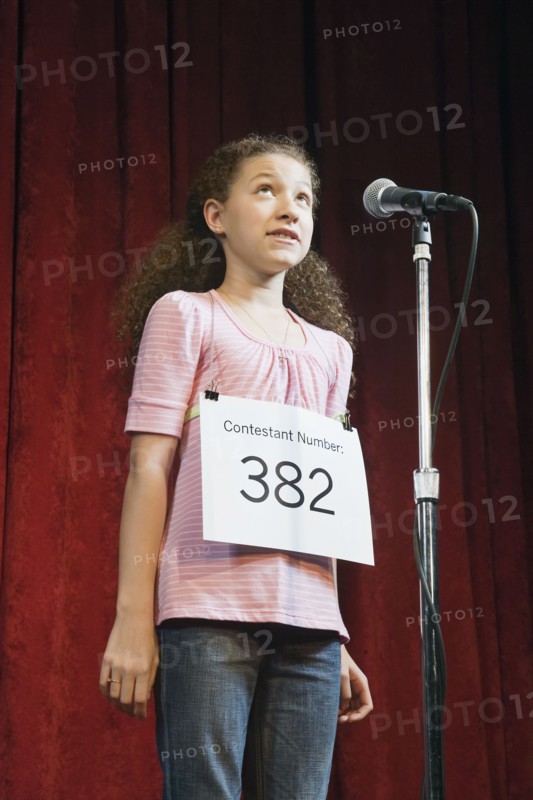 Mixed race girl competing in spelling bee