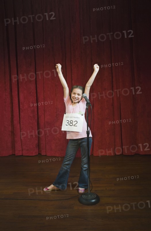 Mixed race girl competing in spelling bee