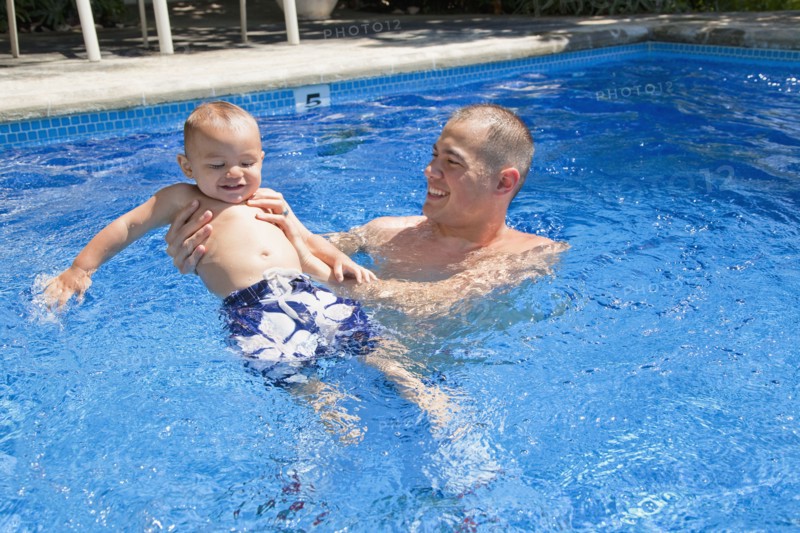 Father playing with son in swimming pool