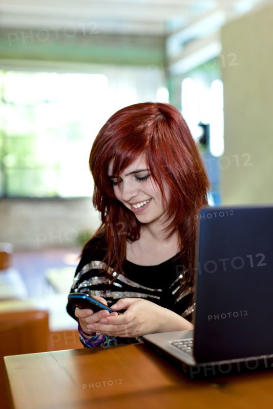 Caucasian teenager text messaging on cell phone