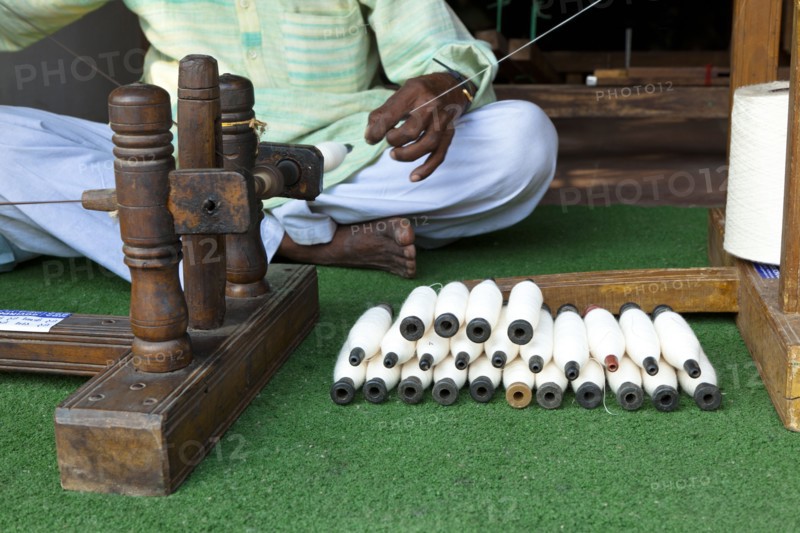 Indian man working with thread