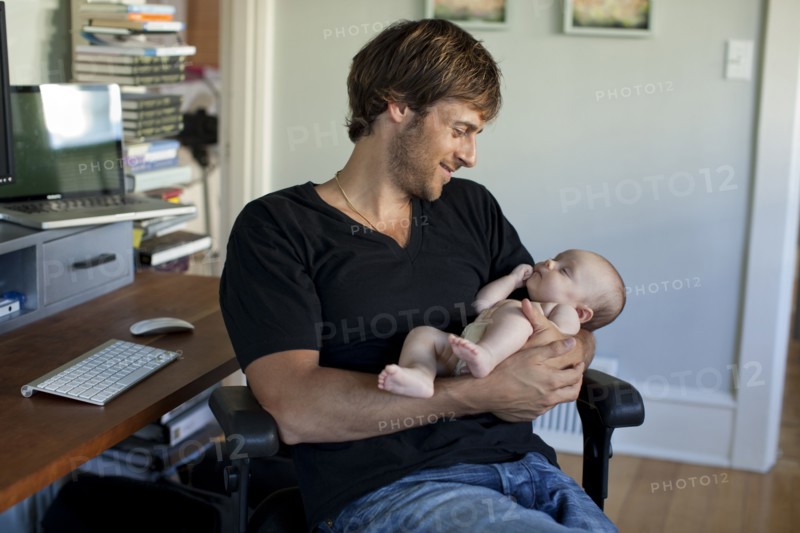 Happy Caucasian father holding baby daughter