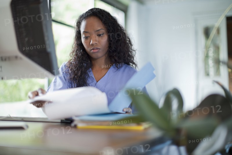 Mixed race woman looking at paperwork