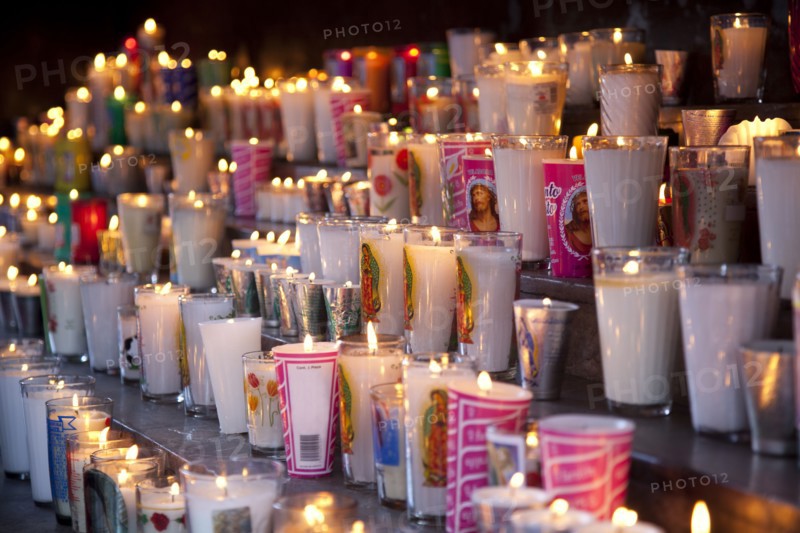Rows of burning religious candles