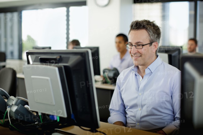 Business people working on computers in office