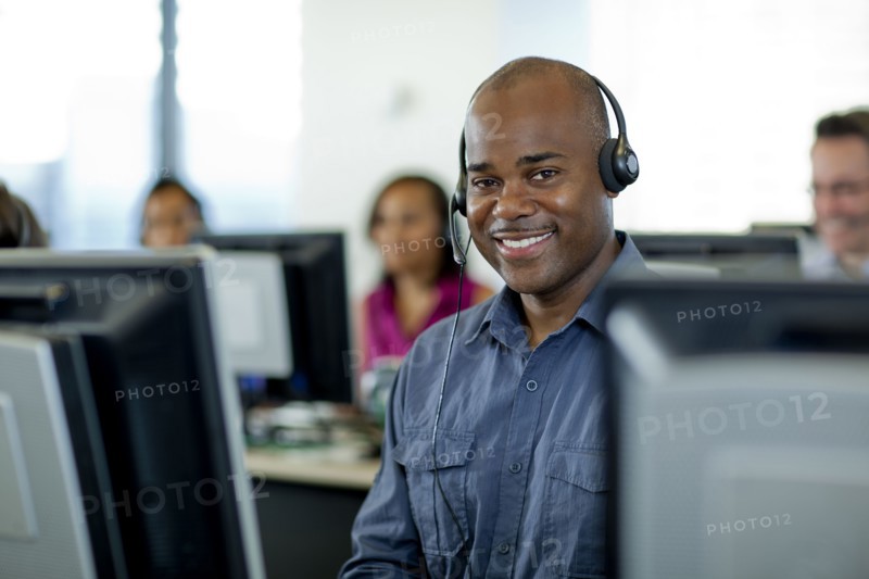 Business people working on computers in call center