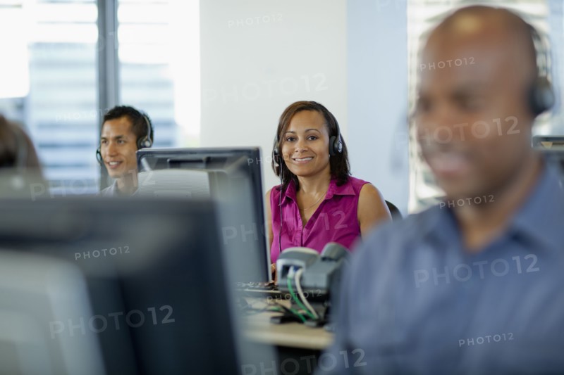 Business people working on computers in call center