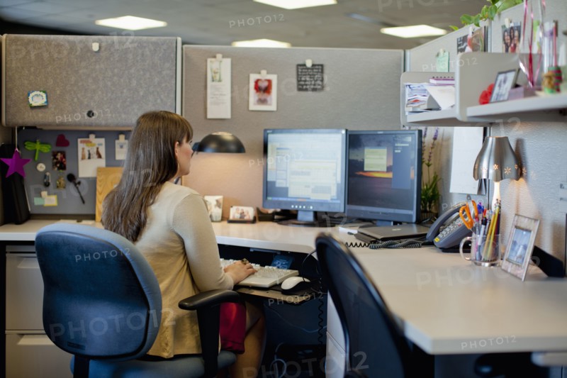 Caucasian businesswoman working at desk in office