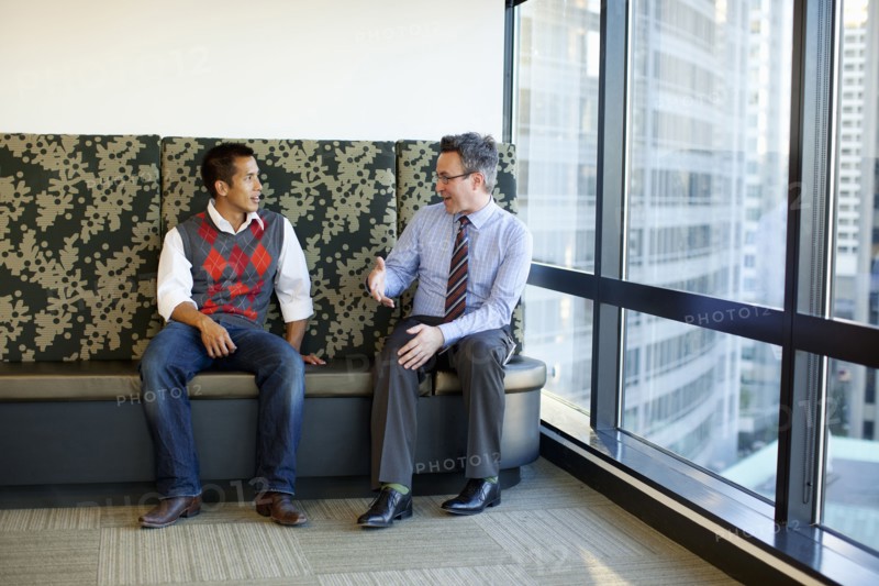 Businessmen talking together in office lobby