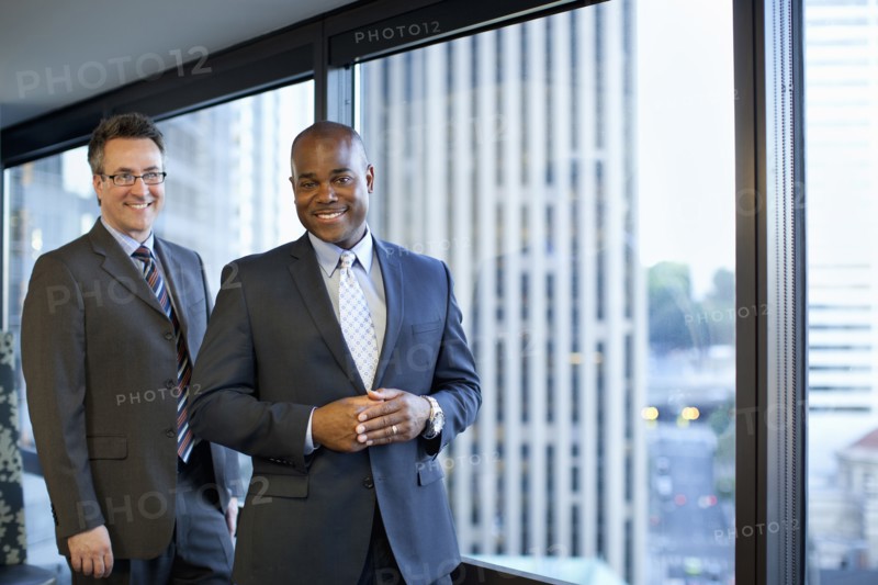 Smiling businessmen standing in office
