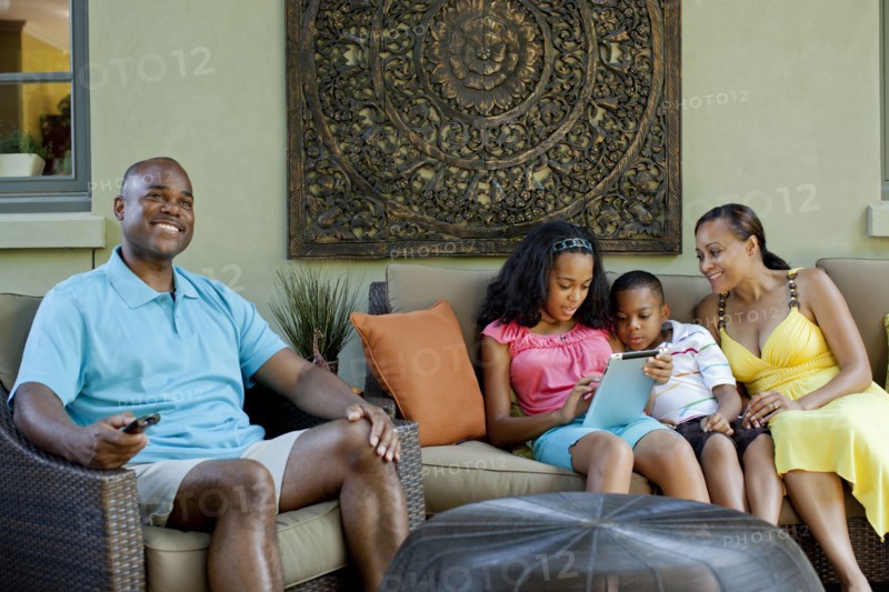 African American family relaxing in living room
