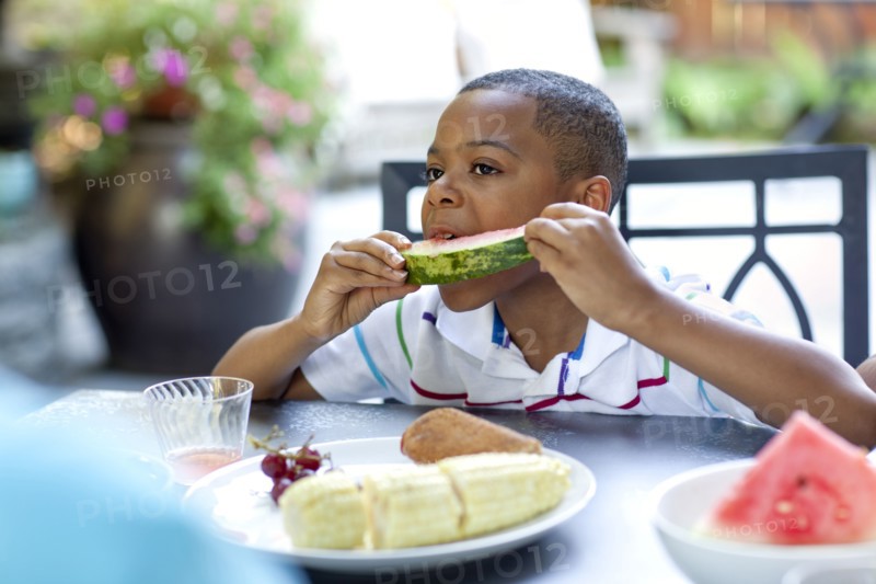 African American boy eating watermelon