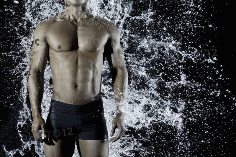 Pacific Islander man getting splashed with water
