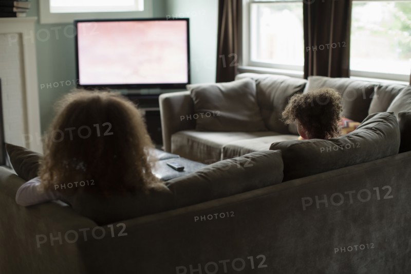Mother and daughter watching television