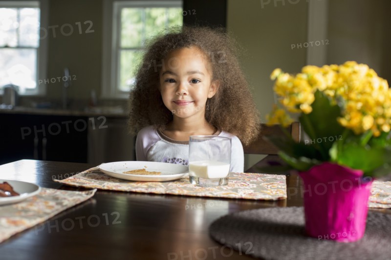 Mixed race girl eating breakfast