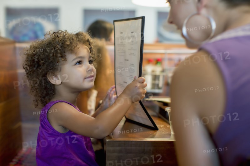 Mother and daughter ordering in restaurant