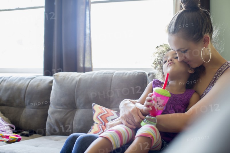 Mother holding daughter on lap