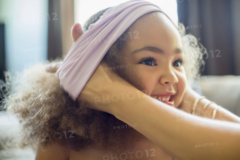 Mother dressing daughter