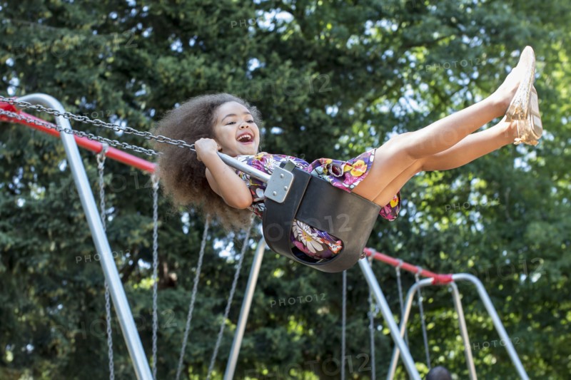 Mixed race girl swinging