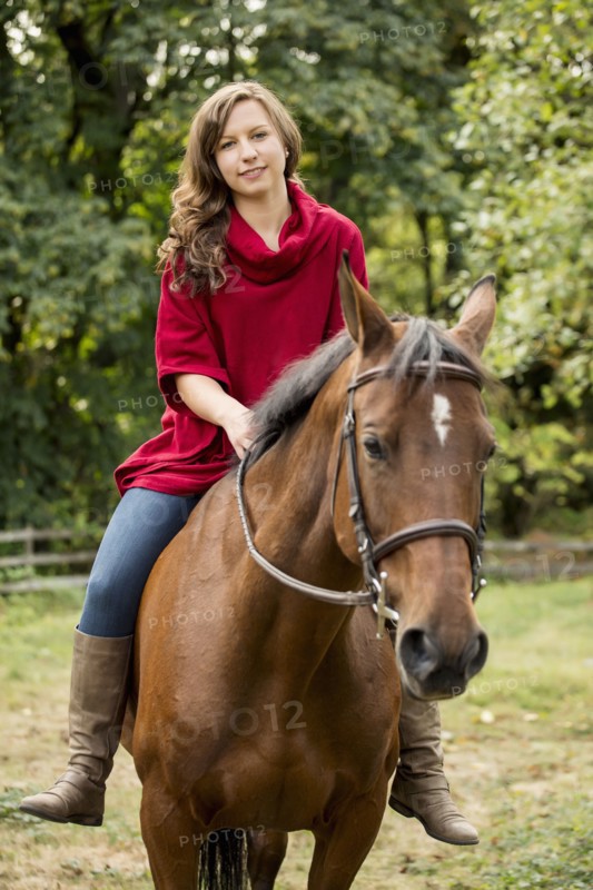 Caucasian woman riding horse outdoors