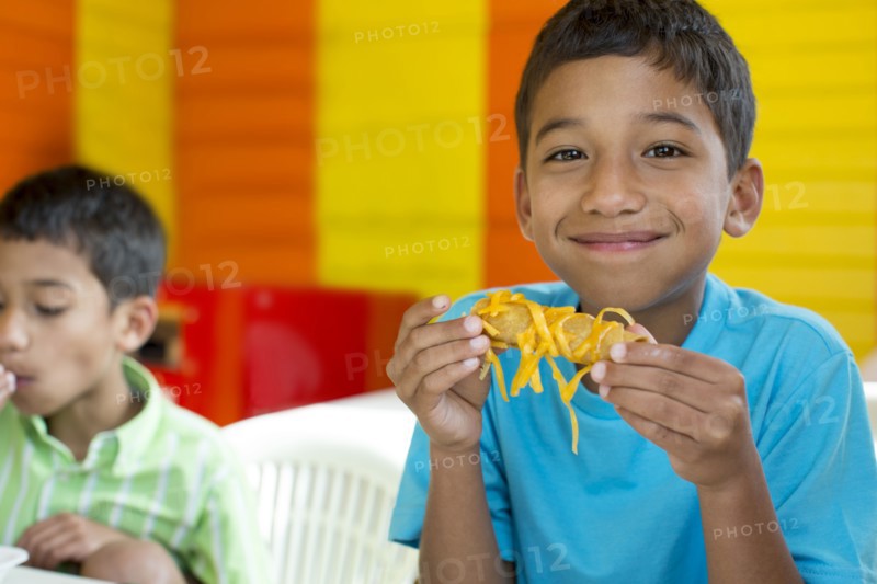 Hispanic boy eating in restaurant