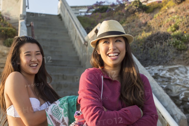 Women standing by steps on beach
