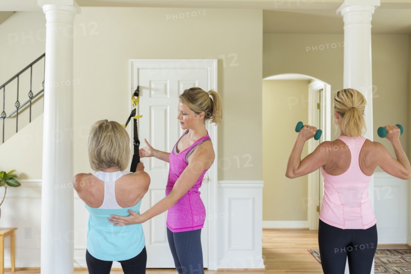 Caucasian women working with trainer in home