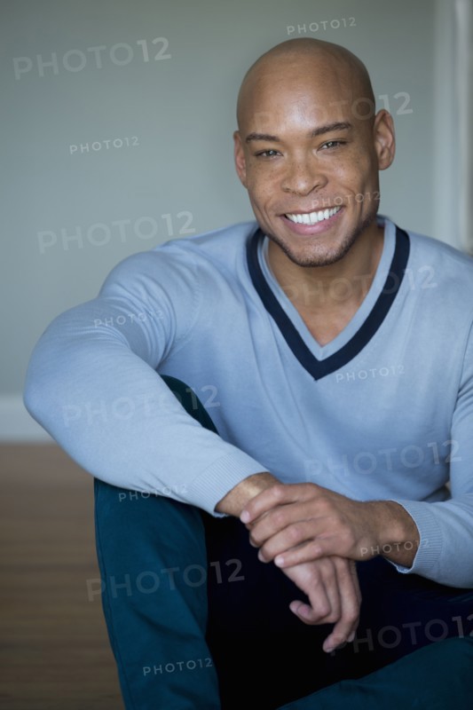 Mixed race man in v-neck sweater