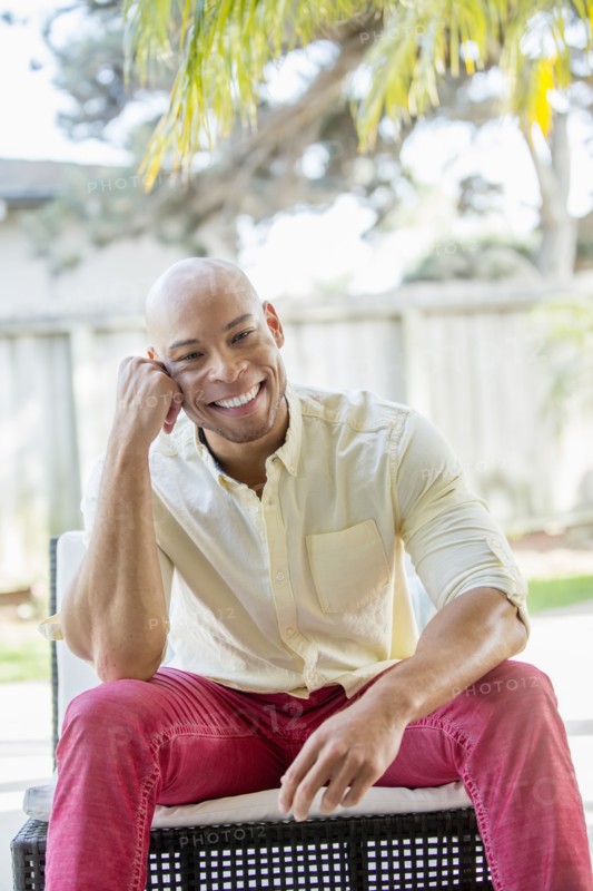 Mixed race man smiling in backyard