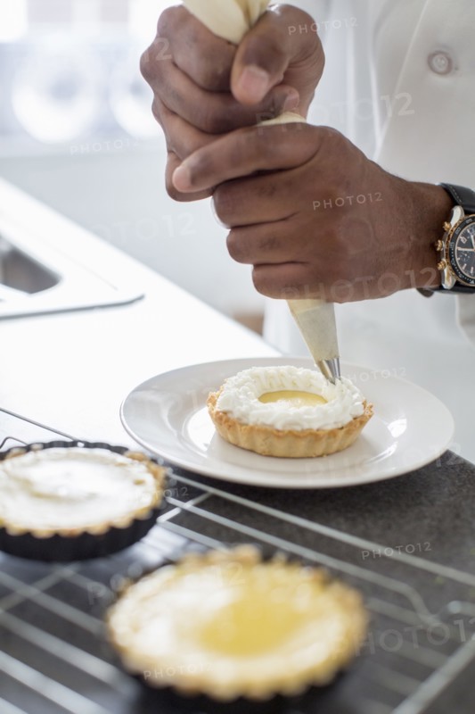 Black chef making key lime tart in restaurant