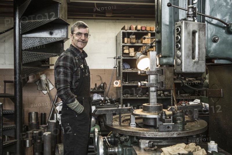 Portrait of Caucasian man smiling in metal shop