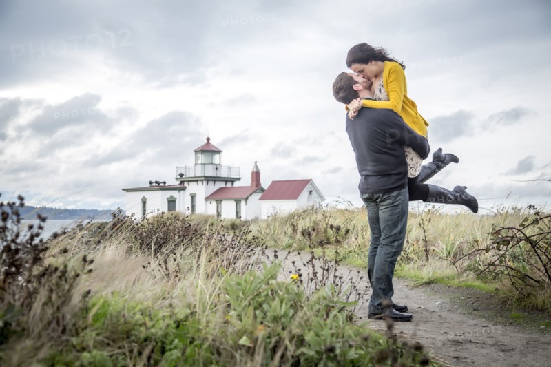 Caucasian couple hugging on beach path