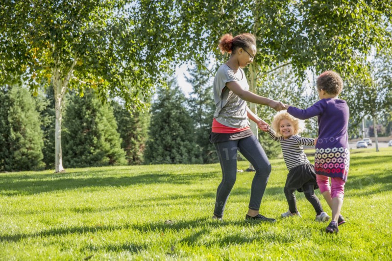 Mixed race sisters playing outdoors