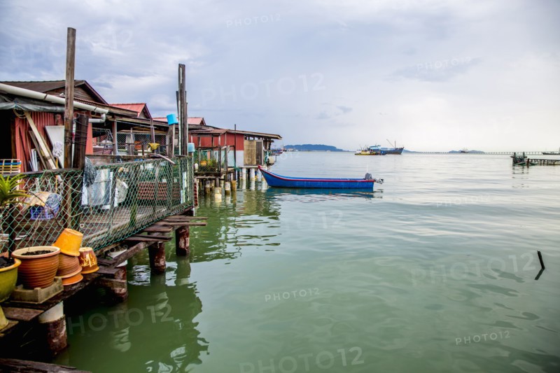 Boat docked along boathouses