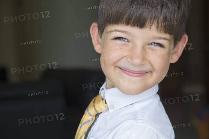 Caucasian boy smiling in formal wear