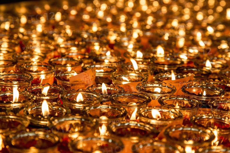 Close up of lit candles with wish notes