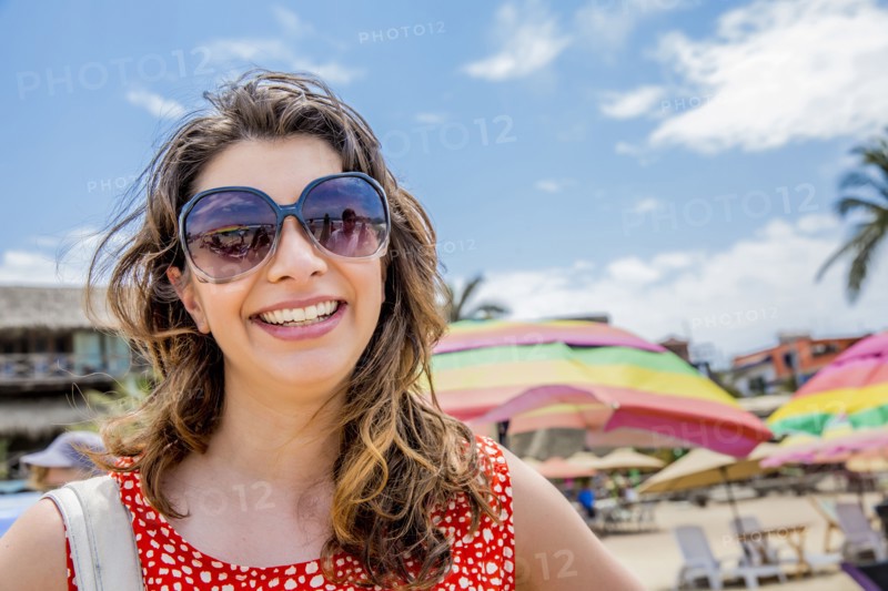 Mixed race woman smiling on tropical beach