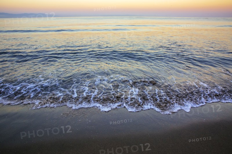 Waves washing up on sandy beach