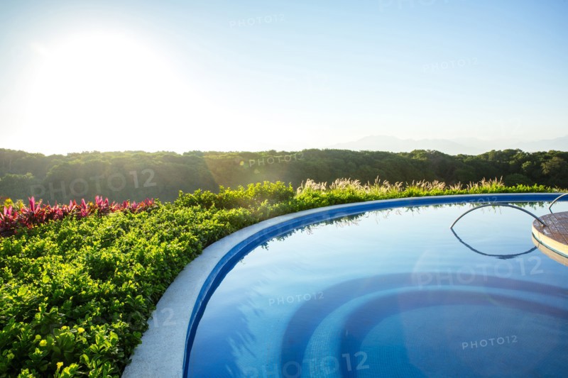 Infinity pool overlooking rural landscape