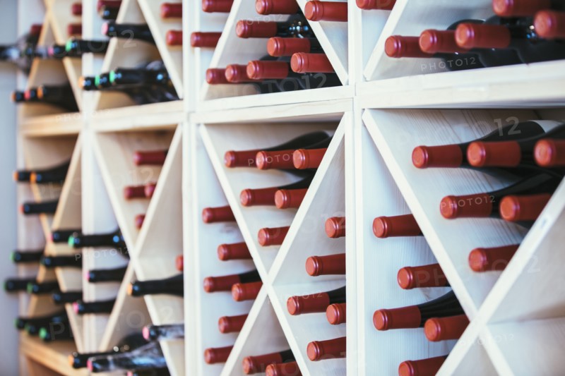 Wine bottles in rack on wall