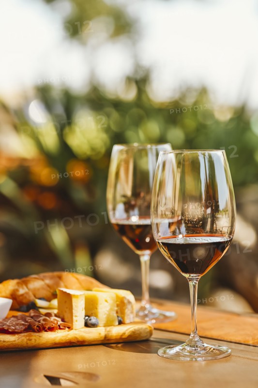 Glasses of wine with cheese and meat board