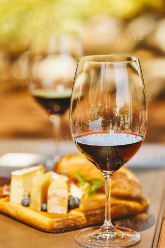 Glasses of wine with cheese and meat board